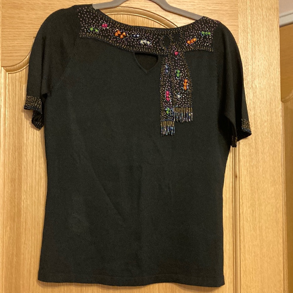 NWOT women top. Size XXXL. 62%rayon, 38%nylon. Hand wash separately.
